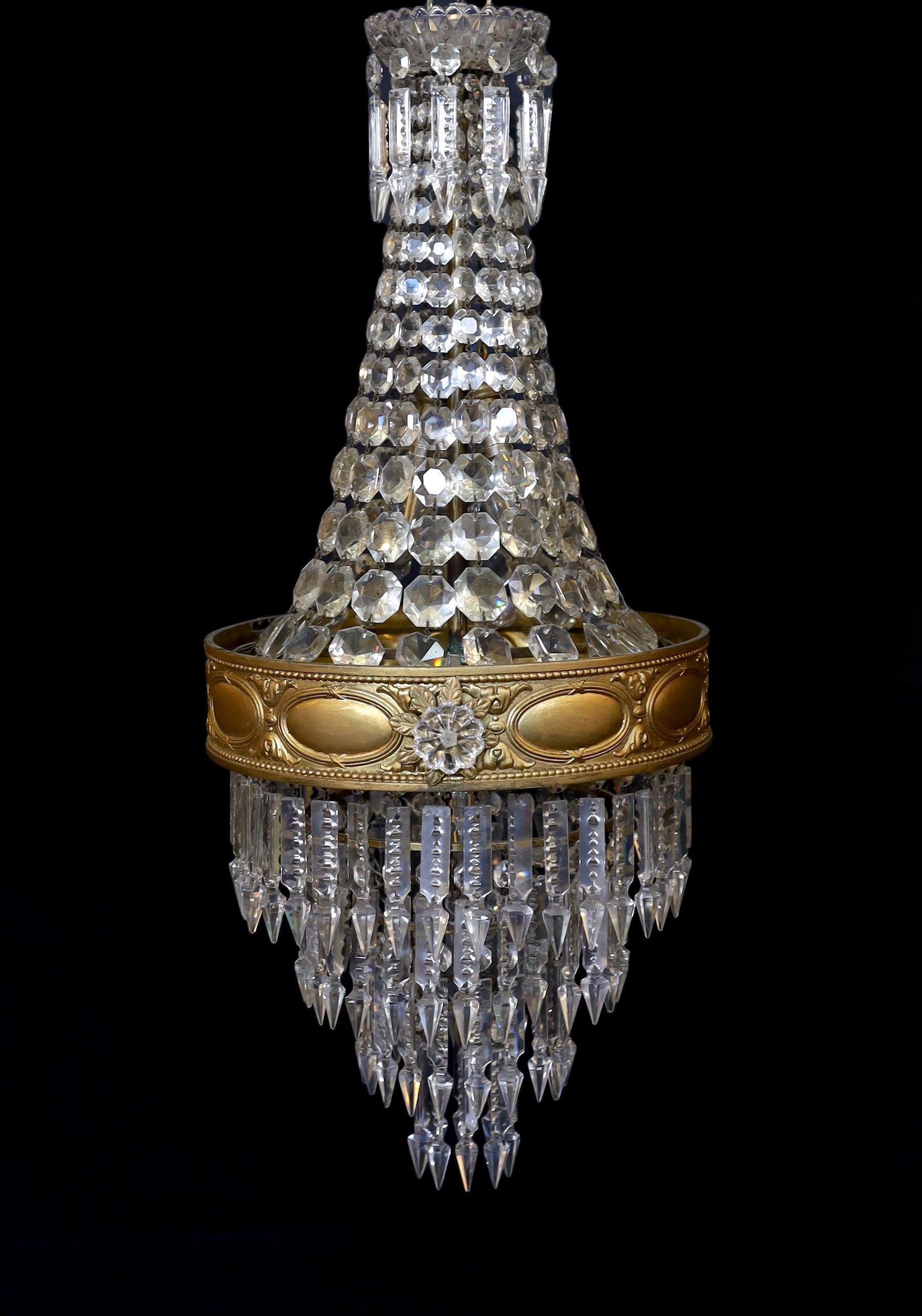 An early 20th century English ormolu and cut glass bag chandelier, hung with octagonal cut drops and spear shaped lustres with four tiers to the base, height 75cm. diameter 35cm